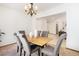 Well-lit dining room with a wooden table, modern chandelier, and a view of the entry at 10273 Nottingham Dr, Parker, CO 80134