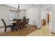 Bright dining room with a modern chandelier and views of the neighborhood through a large window at 10273 Nottingham Dr, Parker, CO 80134