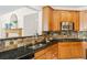 Close-up of the kitchen with stainless steel sink, granite countertops, and stylish wood cabinets at 10273 Nottingham Dr, Parker, CO 80134