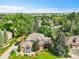 Stunning aerial view of a home surrounded by lush trees and a well-maintained lawn at 1321 Ruby Way, Longmont, CO 80504