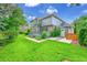 Beautiful backyard featuring a well-maintained lawn, a deck perfect for entertaining, and mature trees at 1321 Ruby Way, Longmont, CO 80504