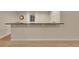 Basement wet bar featuring a granite countertop and white shelving at 1321 Ruby Way, Longmont, CO 80504