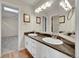 Bright bathroom features a double sink with granite countertop and modern lighting fixtures and opens to the bedroom at 1321 Ruby Way, Longmont, CO 80504
