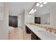 Spacious bathroom featuring a double vanity with tile backsplash and a soaking tub at 1321 Ruby Way, Longmont, CO 80504