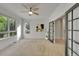 Spacious bedroom with a large window, neutral carpeting, and a stylish ceiling fan at 1321 Ruby Way, Longmont, CO 80504