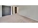 Spacious bedroom with a closet, black doors and neutral colored carpet at 1321 Ruby Way, Longmont, CO 80504
