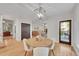 Cozy dining area with a chandelier and a view of the living room with fireplace at 1321 Ruby Way, Longmont, CO 80504