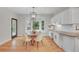 A naturally lit dining area featuring a round table, bay window, and adjacent kitchen space at 1321 Ruby Way, Longmont, CO 80504