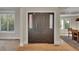 Elegant entryway featuring a solid wood door with sidelights and hardwood floors, creating a warm welcome at 1321 Ruby Way, Longmont, CO 80504