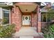 Charming brick home featuring a welcoming front entrance with a wreath-adorned door at 1321 Ruby Way, Longmont, CO 80504