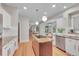 Charming kitchen with stainless appliances, an island cooktop, and a bright dining area in view at 1321 Ruby Way, Longmont, CO 80504