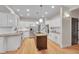 Modern kitchen featuring stainless steel appliances, a kitchen island, and ample white cabinetry at 1321 Ruby Way, Longmont, CO 80504