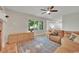 Open living space featuring a large window, fireplace, and adjacent kitchen and dining area at 1321 Ruby Way, Longmont, CO 80504