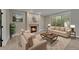 Cozy living room featuring a fireplace, plush seating, and a large window with natural light at 1321 Ruby Way, Longmont, CO 80504