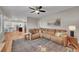 Open-concept living room with hardwood floors, a ceiling fan, and comfortable seating at 1321 Ruby Way, Longmont, CO 80504