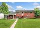 This is a backyard featuring a well-maintained lawn, brick house, and an inviting outdoor picnic space at 6721 Quay Ct, Arvada, CO 80003