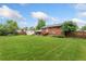 Large backyard with a green lawn and a view of the house at 6721 Quay Ct, Arvada, CO 80003