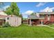 Backyard with a shed and covered patio, offering outdoor storage and entertainment space at 6721 Quay Ct, Arvada, CO 80003