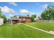 Spacious backyard with a covered patio and a well-maintained lawn at 6721 Quay Ct, Arvada, CO 80003