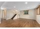 Spacious finished basement area with wood-look flooring, stairs, and a window providing natural light at 6721 Quay Ct, Arvada, CO 80003