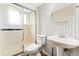 Small bathroom featuring patterned walls, a toilet, a sink and a shower at 6721 Quay Ct, Arvada, CO 80003