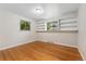 Bright bedroom with hardwood floors and built-in shelving around the windows, creating a cozy and organized space at 6721 Quay Ct, Arvada, CO 80003