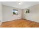 Charming bedroom with hardwood floors, neutral walls, and two windows allowing ample natural light at 6721 Quay Ct, Arvada, CO 80003