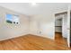 Inviting bedroom with hardwood floors, neutral walls, a window, and closet access at 6721 Quay Ct, Arvada, CO 80003
