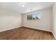 Bedroom featuring modern wood flooring and natural light from the window at 6721 Quay Ct, Arvada, CO 80003
