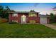 Charming brick home with a well-kept lawn and garden beds enhancing curb appeal at 6721 Quay Ct, Arvada, CO 80003