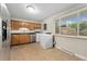 Bright kitchen featuring white appliances, tile backsplash, and exterior access at 6721 Quay Ct, Arvada, CO 80003