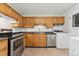 Traditional kitchen with stainless steel appliances and plenty of counter space at 6721 Quay Ct, Arvada, CO 80003