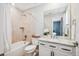 Bathroom with shower/tub combo, granite countertops, and under sink storage at 9446 E 51St Dr, Denver, CO 80238