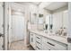 Bathroom with double sinks, granite countertops, and plenty of storage at 9446 E 51St Dr, Denver, CO 80238