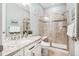 Well-lit bathroom featuring a glass-enclosed shower, vanity with stylish fixtures, and tiled walls at 9446 E 51St Dr, Denver, CO 80238