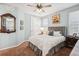 Cozy bedroom with neutral tones, ceiling fan, and complementing decor with a quaint bedside table at 9446 E 51St Dr, Denver, CO 80238