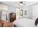 Bright bedroom with a laundry closet, view of the ensuite bathroom, and classic decorative touches at 9446 E 51St Dr, Denver, CO 80238