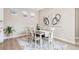 Bright dining room with neutral decor, art, and a view of the outside at 9446 E 51St Dr, Denver, CO 80238
