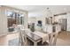 Dining area with sliding glass doors, flows into the kitchen and living room, creating a connected, spacious feel at 9446 E 51St Dr, Denver, CO 80238