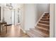 Bright entryway with hardwood floors and stairs leading to the upper level at 9446 E 51St Dr, Denver, CO 80238