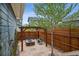 Inviting outdoor fire pit area surrounded by a wooden privacy fence and a swing, ideal for leisure at 9446 E 51St Dr, Denver, CO 80238