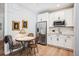 Kitchen with white cabinets, stainless steel appliances, and dining table at 9446 E 51St Dr, Denver, CO 80238