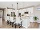 Modern kitchen featuring white cabinetry, stainless steel appliances, and a granite island with seating at 9446 E 51St Dr, Denver, CO 80238