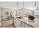 Spacious kitchen island with granite countertops, stainless steel sink, and an open view to the living and dining areas at 9446 E 51St Dr, Denver, CO 80238