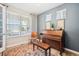 Inviting living room with a window, beautiful decor, and a vintage piano at 9446 E 51St Dr, Denver, CO 80238