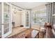 Cozy living room with French doors, hardwood floors, a large window, and stylish decor at 9446 E 51St Dr, Denver, CO 80238