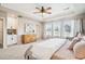 Bright main bedroom with a tray ceiling, lots of windows, and a built-in cabinet at 9446 E 51St Dr, Denver, CO 80238