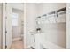 Organized mudroom with built-in storage, bench seating, and convenient access to a half-bathroom at 9446 E 51St Dr, Denver, CO 80238