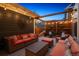Inviting outdoor patio with comfortable seating, stylish decor, and ambient string lights for relaxing evenings at 9446 E 51St Dr, Denver, CO 80238