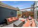 Relaxing patio area featuring comfortable outdoor seating and ambient lighting with privacy screen at 9446 E 51St Dr, Denver, CO 80238